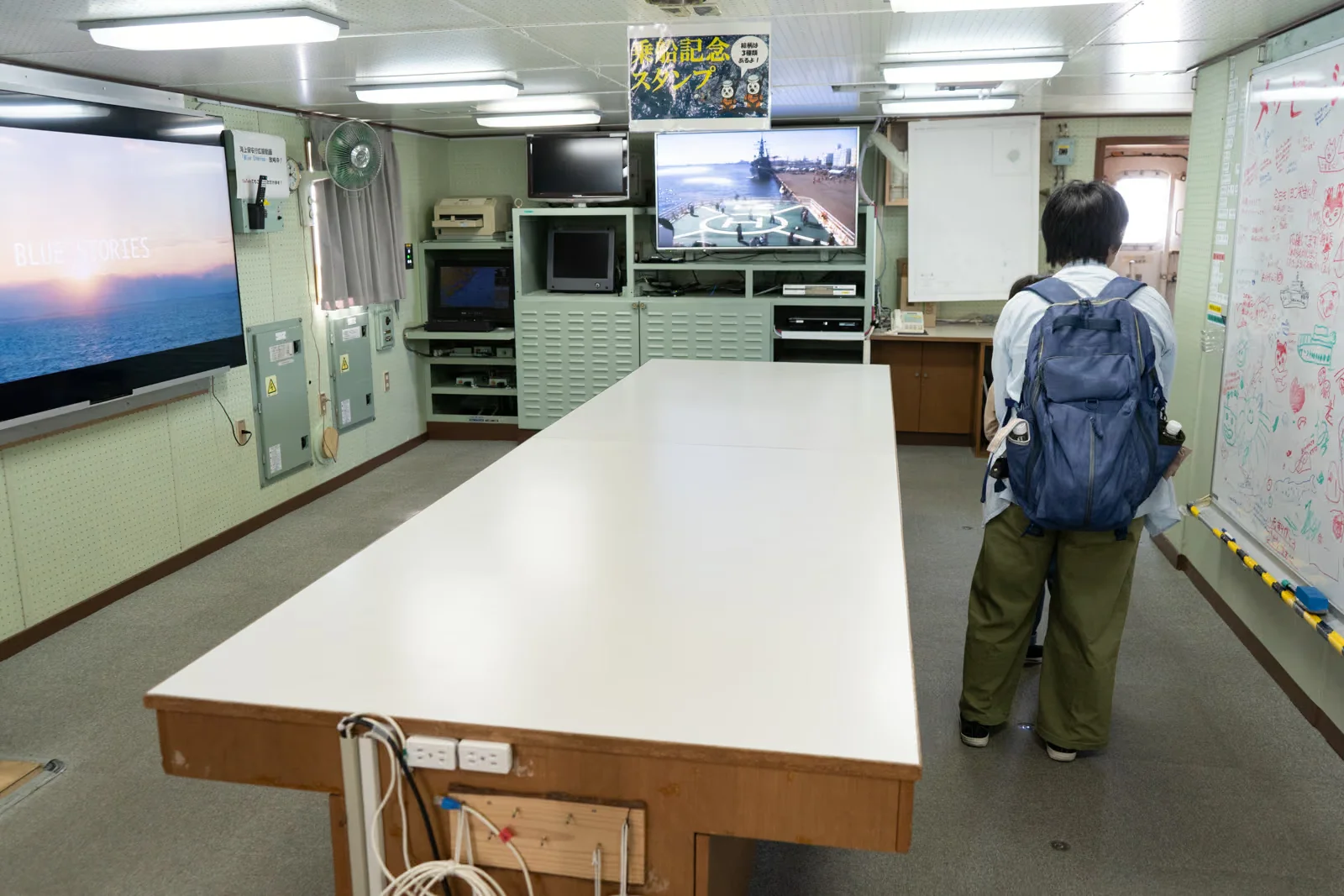 巡視船いずの大型テーブルとモニターが設置された船内の部屋